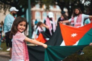 A girl holding onto the flag of palestine