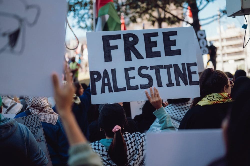 A group of people holding up signs that say free palestine.